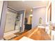Bathroom featuring a glass door shower, wood look floors, vanity, and walk-in closet at 979 Natchez Trce, Fuquay Varina, NC 27526