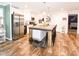 A modern kitchen boasts stainless steel appliances and a spacious island with seating, perfect for entertaining at 979 Natchez Trce, Fuquay Varina, NC 27526