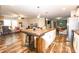 An expansive kitchen island with wooden countertop complements the white cabinetry in this spacious open-concept living space at 979 Natchez Trce, Fuquay Varina, NC 27526