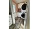 A well-organized laundry room featuring stacked washer and dryer units for space-saving convenience at 979 Natchez Trce, Fuquay Varina, NC 27526