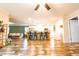 Spacious open-concept living room featuring wood floors, a center island, and a combined kitchen area at 979 Natchez Trce, Fuquay Varina, NC 27526