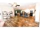 Open-concept living room with wood floors, a kitchen island, and an adjacent lounge area at 979 Natchez Trce, Fuquay Varina, NC 27526