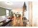 Comfortable living room boasts a neutral sofa, wood-look flooring, and a view of the open-concept kitchen and dining area at 979 Natchez Trce, Fuquay Varina, NC 27526