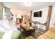 Inviting living room with modern shiplap wall design, rustic wood beam accents, and an open flow to the kitchen at 979 Natchez Trce, Fuquay Varina, NC 27526