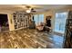 Bright living room with built-in shelves, wood floors, and a view of the outdoor space at 979 Natchez Trce, Fuquay Varina, NC 27526