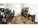 A shared office featuring two computer setups, wood grain flooring, and dual bookshelves at 979 Natchez Trce, Fuquay Varina, NC 27526