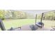 Relaxing back porch with outdoor seating and a scenic view of the green backyard at 147 Charlotte Knoll St # 14, Zebulon, NC 27597
