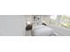 Comfortable bedroom with a plush bed, side tables, lamps, and bright windows overlooking greenery at 147 Charlotte Knoll St # 14, Zebulon, NC 27597