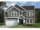 Two-story home with gray siding, white trim, and a two-car garage at 147 Charlotte Knoll St # 14, Zebulon, NC 27597
