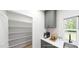 Bright pantry with ample shelving, modern appliances, and grey cabinetry at 147 Charlotte Knoll St # 14, Zebulon, NC 27597