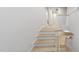 Bright staircase with light wood treads and white risers and railings leads to the upper level at 147 Charlotte Knoll St # 14, Zebulon, NC 27597