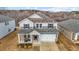 Two-story house with gray and blue siding, a two-car garage, and a front porch at 1007 Cherry Stem Rd, Haw River, NC 27258