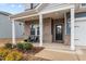 Brick front porch with seating area and access to the front door at 1007 Cherry Stem Rd, Haw River, NC 27258