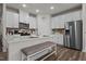 Modern kitchen with white cabinets, island, and stainless steel appliances at 1007 Cherry Stem Rd, Haw River, NC 27258