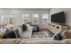 Living room with sectional sofa, large TV, and wood-look flooring at 1007 Cherry Stem Rd, Haw River, NC 27258