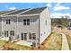 Exterior rear view of townhome featuring a backyard with a patio and newly installed landscaping at 103 Central Townes Way # 297, Raleigh, NC 27603