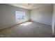 Spacious bedroom with carpeted floor, a ceiling fan, and a bright window overlooking the neighborhood at 103 Central Townes Way # 297, Raleigh, NC 27603