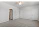 Another view of the spacious bedroom featuring plush carpet, ceiling fan, and two closets at 103 Central Townes Way # 297, Raleigh, NC 27603