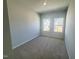 Bright bedroom with two windows providing natural light and neutral carpet at 103 Central Townes Way # 297, Raleigh, NC 27603