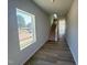Bright entryway with wood-look flooring, stairs, and a view to the outside through a large window at 103 Central Townes Way # 297, Raleigh, NC 27603