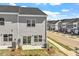 Street view of townhomes showing siding, sidewalk, and landscaping at 103 Central Townes Way # 297, Raleigh, NC 27603