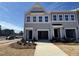 New construction townhome features a two-car garage and beautifully landscaped front yard at 103 Central Townes Way # 297, Raleigh, NC 27603