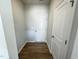 Hallway featuring wood-look floors and doors to additional rooms and storage at 103 Central Townes Way # 297, Raleigh, NC 27603