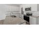 Modern kitchen featuring white cabinets, stainless steel appliances, and granite countertops at 103 Central Townes Way # 297, Raleigh, NC 27603