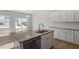 Open kitchen featuring an island with a sink and stainless steel dishwasher at 103 Central Townes Way # 297, Raleigh, NC 27603