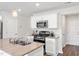 Well-equipped kitchen featuring white cabinets, granite countertops, stainless steel appliances, and hardwood floors at 103 Central Townes Way # 297, Raleigh, NC 27603