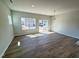 Open living room featuring wood-look floors, natural light, and sliding glass door to the backyard at 103 Central Townes Way # 297, Raleigh, NC 27603