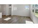 Bright living room featuring wood-look flooring, large windows, and natural light at 103 Central Townes Way # 297, Raleigh, NC 27603