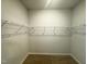 Walk-in closet featuring ample wire shelving and neutral carpeting at 103 Central Townes Way # 297, Raleigh, NC 27603