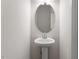 Small bathroom featuring pedestal sink, framed mirror, and overhead lighting at 104 Central Townes Way # 296, Raleigh, NC 27603