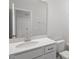 Bathroom vanity with single sink and faucet, and a framed mirror above at 104 Central Townes Way # 296, Raleigh, NC 27603