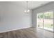 Dining area with wood-look floors, chandelier and sliding glass door at 104 Central Townes Way # 296, Raleigh, NC 27603
