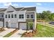 New construction townhomes with attached garages and professionally landscaped front yards at 104 Central Townes Way # 296, Raleigh, NC 27603