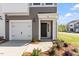 Charming townhome with a single car garage, black front door and professionally landscaped yard at 104 Central Townes Way # 296, Raleigh, NC 27603