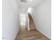 Hallway with wood floors leading to carpeted stairs and a bright living space at 104 Central Townes Way # 296, Raleigh, NC 27603