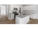 Well-equipped kitchen with granite island, stainless appliances, and stylish backsplash at 104 Central Townes Way # 296, Raleigh, NC 27603