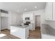 Bright kitchen features white cabinets, granite countertops, stainless appliances, and wood-look flooring at 104 Central Townes Way # 296, Raleigh, NC 27603