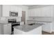 Modern kitchen with stainless steel appliances, granite countertops, and white cabinetry at 104 Central Townes Way # 296, Raleigh, NC 27603