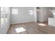 Bright living area with wood-look floors and large windows at 104 Central Townes Way # 296, Raleigh, NC 27603