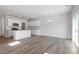 Open floor plan featuring modern kitchen, light filled living room and sliding glass doors at 104 Central Townes Way # 296, Raleigh, NC 27603