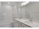 Bathroom with double sink vanity and a bathtub with tile surround at 107 Central Townes Way # 298, Raleigh, NC 27603