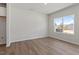 Bedroom features wood floors, large window and neutral paint at 107 Central Townes Way # 298, Raleigh, NC 27603
