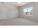 Bright bedroom featuring neutral carpet and a large window at 107 Central Townes Way # 298, Raleigh, NC 27603