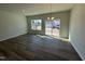 Dining room with luxury vinyl floors and sliding glass doors at 107 Central Townes Way # 298, Raleigh, NC 27603