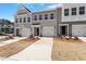 New construction townhomes with driveways and front yards at 107 Central Townes Way # 298, Raleigh, NC 27603