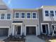 Charming townhouse featuring a one-car garage and modern facade at 107 Central Townes Way # 298, Raleigh, NC 27603